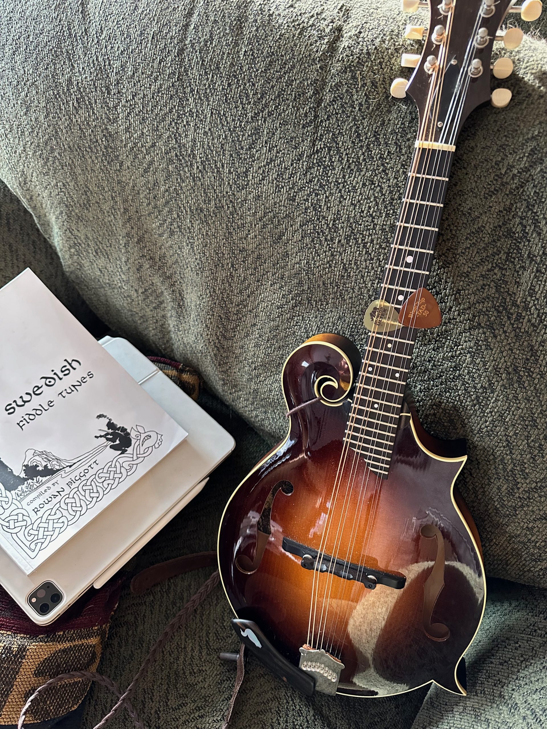 An f-style mandolin with a book of Swedish fiddle tunes.